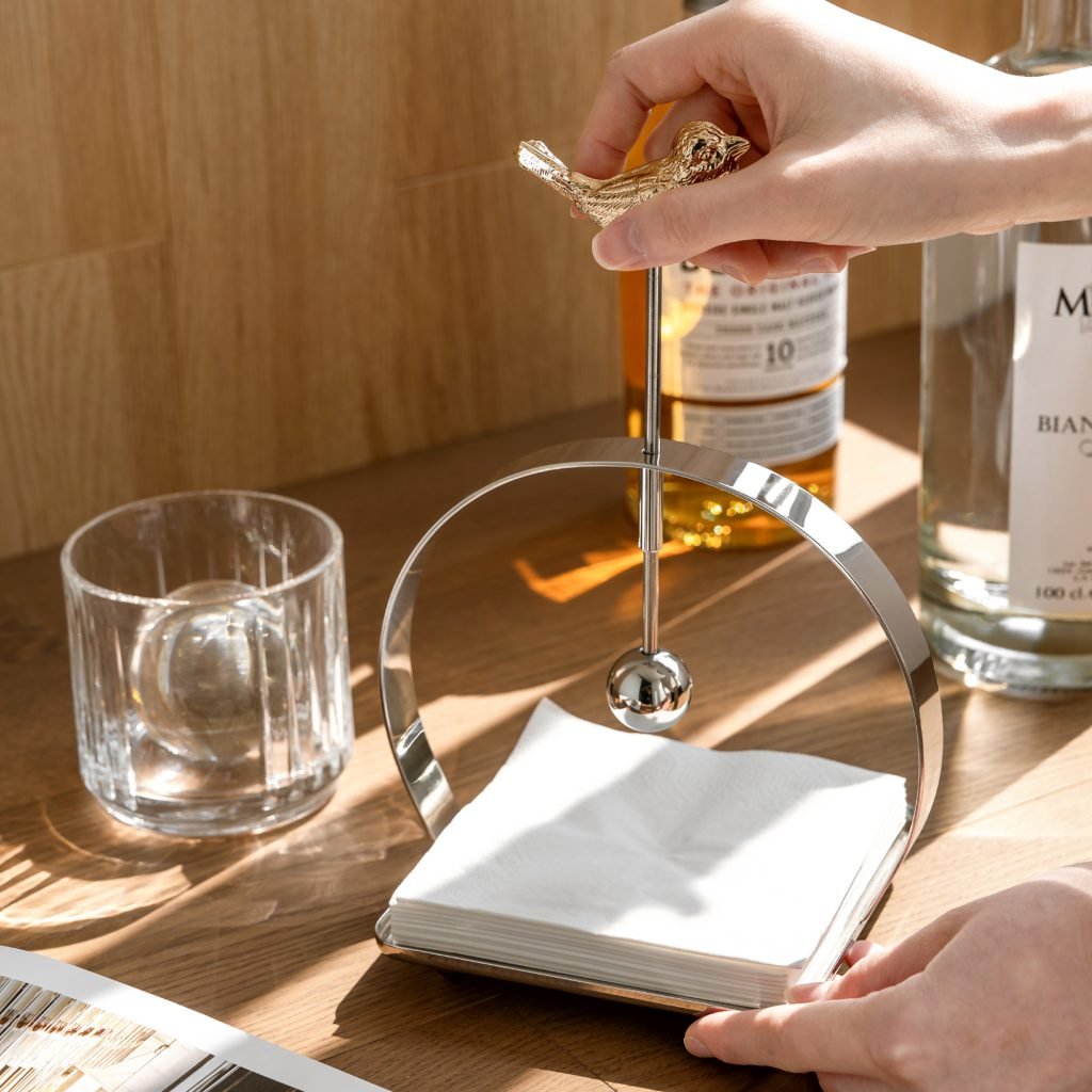 Steel Napkin Holder (SS-100) featuring a solid mirror-polished U-shaped frame holding white napkins, showcased as a Luxury Mirror Polished Tissue Stand.