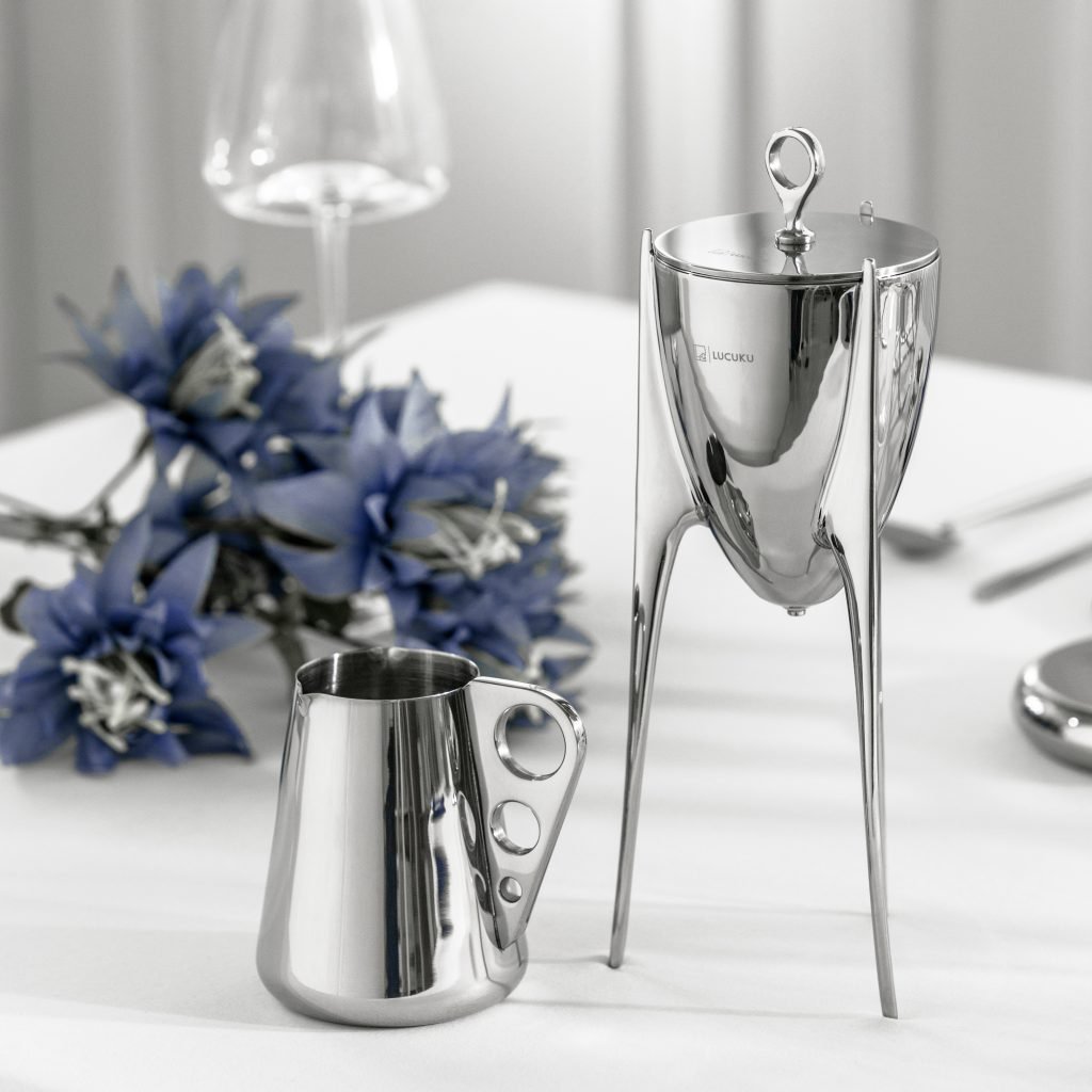 Steel Ding Pitcher (SS-21) featuring a mirror-polished body with ancient tripod-inspired proportions and a dramatic arcing handle, showcased as a Luxury Mirror Polished Cultural Server.