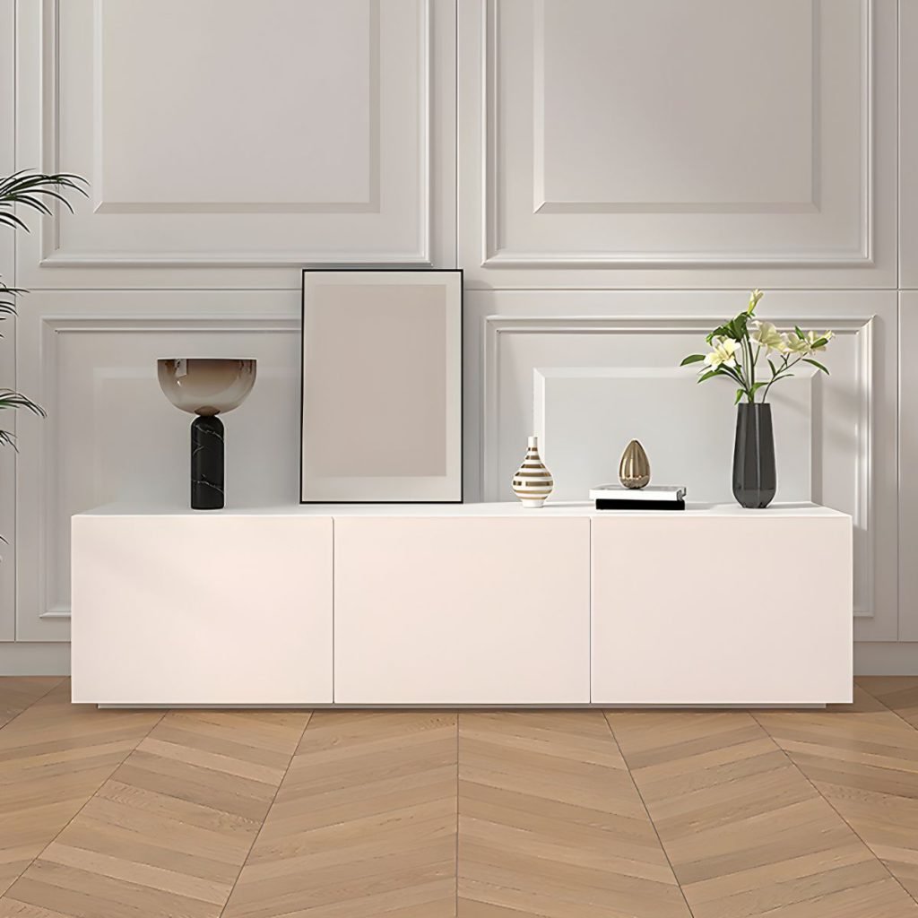 Apexerahomelife Sleek Modern White TV Console showing an 86.5-inch seamless design with four handless doors and soft-close storage in a modern French-paneled living room.