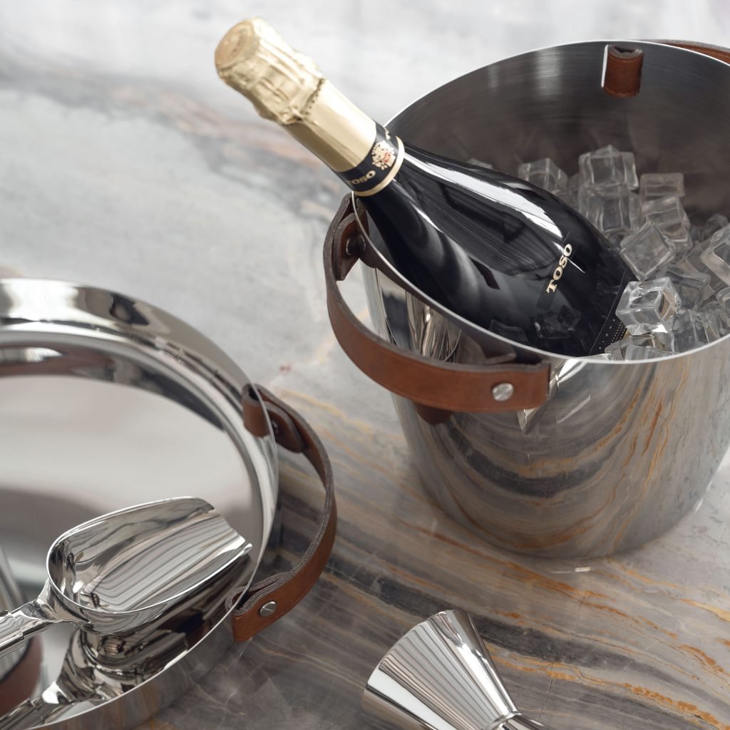 Leather Ice Bucket featuring a dark stitched leather wrap and stainless steel tongs, showcased as an Artisan Hand-Stitched Barware piece.