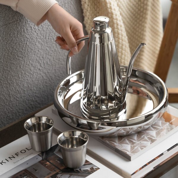 Steel Coffee Set featuring a cylindrical coffee pot and matching server, showcased as an Executive Metallic Coffee Service on a minimalist surface.