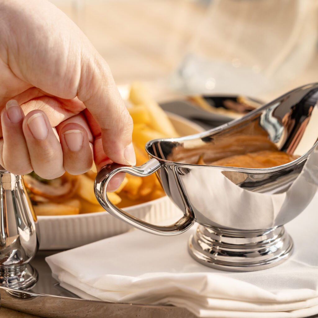 154 3 1 Mirror Gravy Boat for Fine Dining, Luxury Stainless Steel Sauce Pitcher with Ergonomic Handle and Seamless Spout.