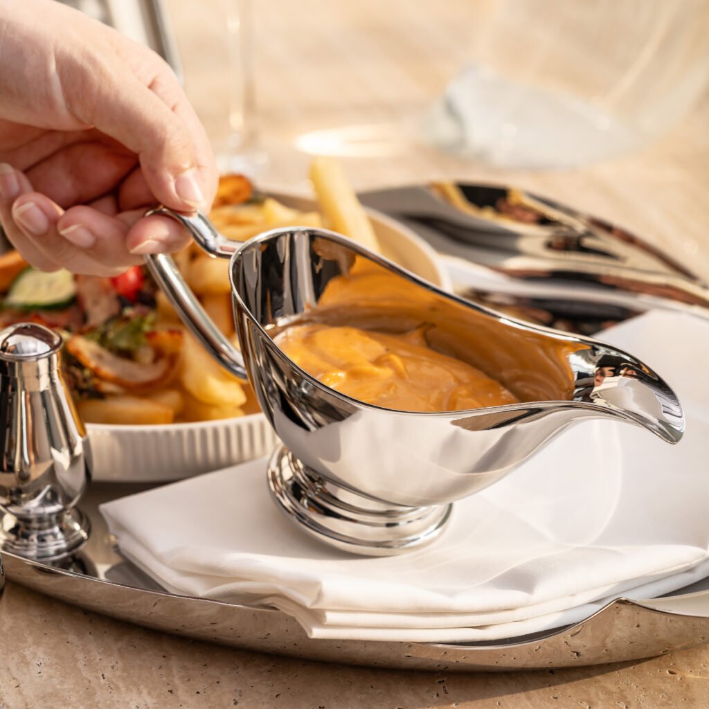 154 4 1 Mirror Gravy Boat for Fine Dining, Luxury Stainless Steel Sauce Pitcher with Ergonomic Handle and Seamless Spout.