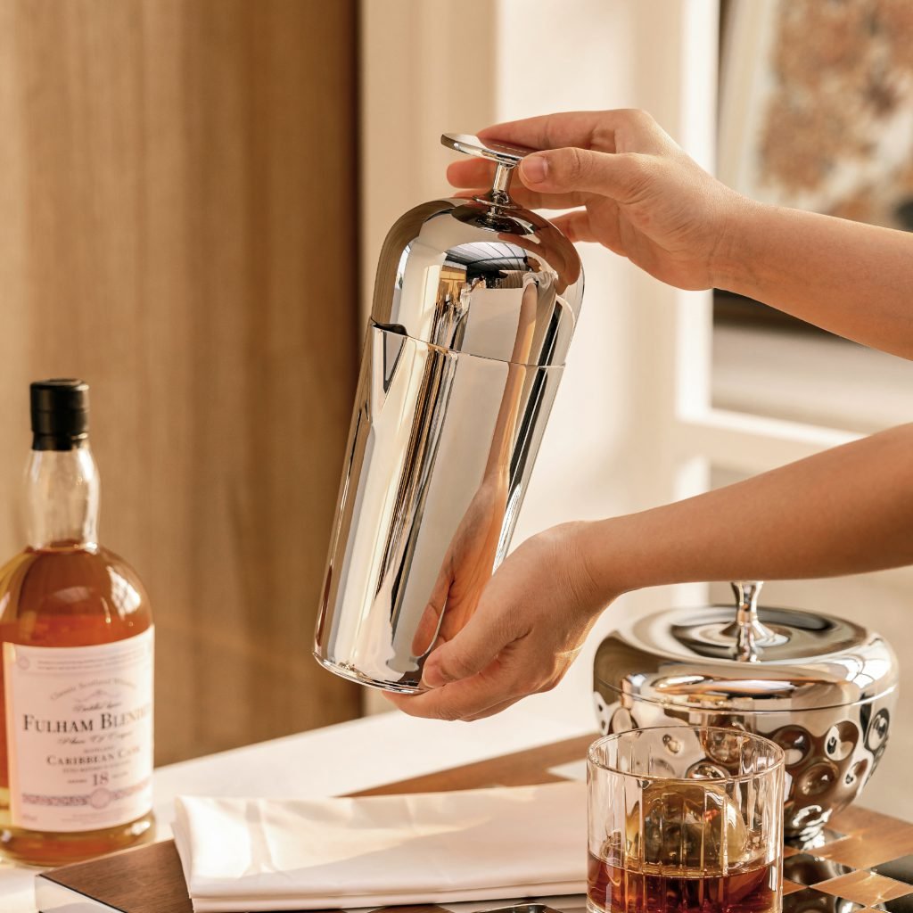 stainlessMirror Stainless Steel Shaker with ergonomic T-handle, shown in an action shot for a professional home bar setup.-steel-159