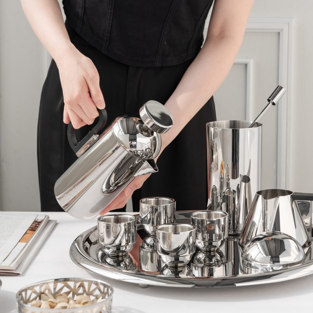 Steel Coffee Set featuring a coffee pot and creamer, showcased as an Executive Metallic Coffee Service on a minimalist background.