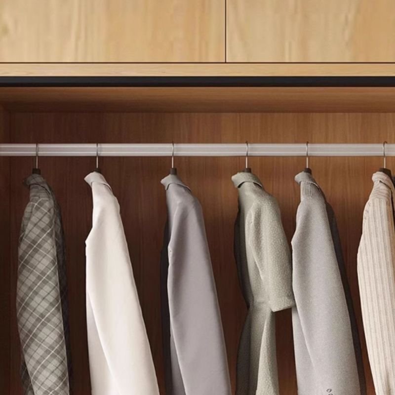 Interior view of a Tall Wooden Bedroom Armoire showing reinforced hanging rails, movable shelves, and smooth-gliding tracks for a Large Scale Modular Closet Project.