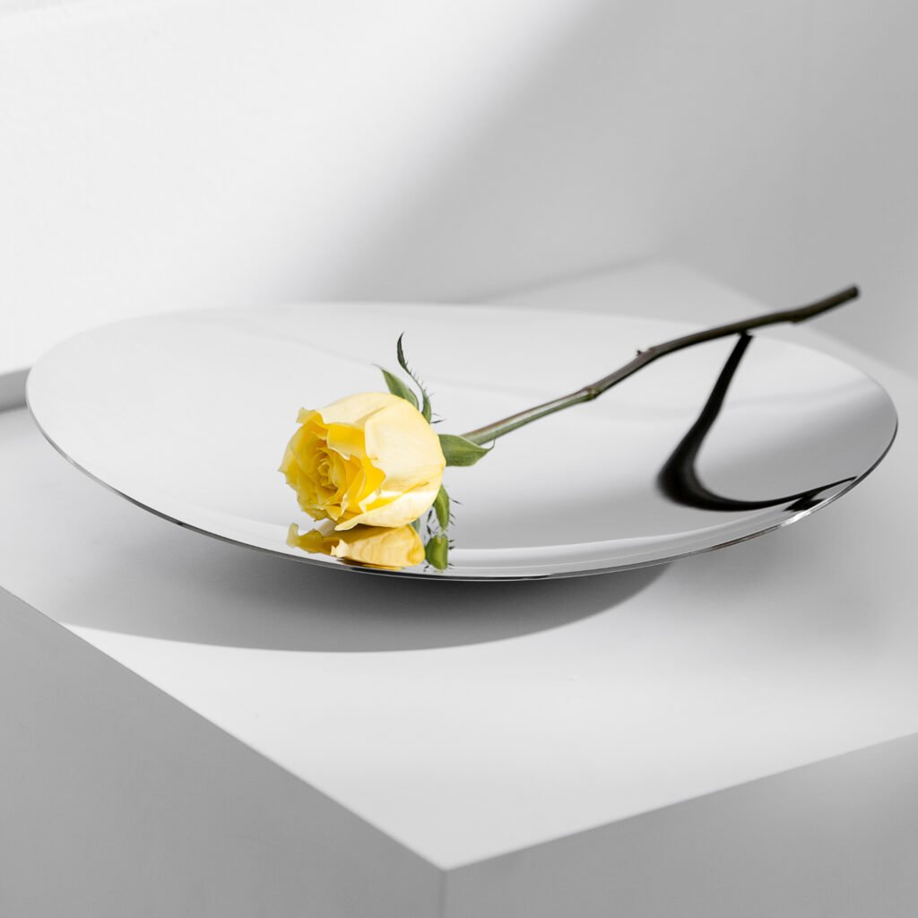 Close-up of the Modernist Deconstructive Metalware, highlighting the intricate light play across the crinkled steel texture and the flawless reflective finish.