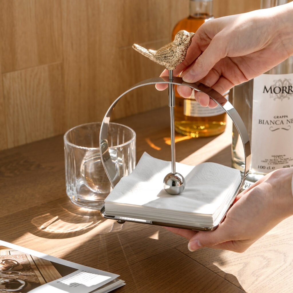 Steel Napkin Holder (SS-100) featuring a solid mirror-polished U-shaped frame holding white napkins, showcased as a Luxury Mirror Polished Tissue Stand.
