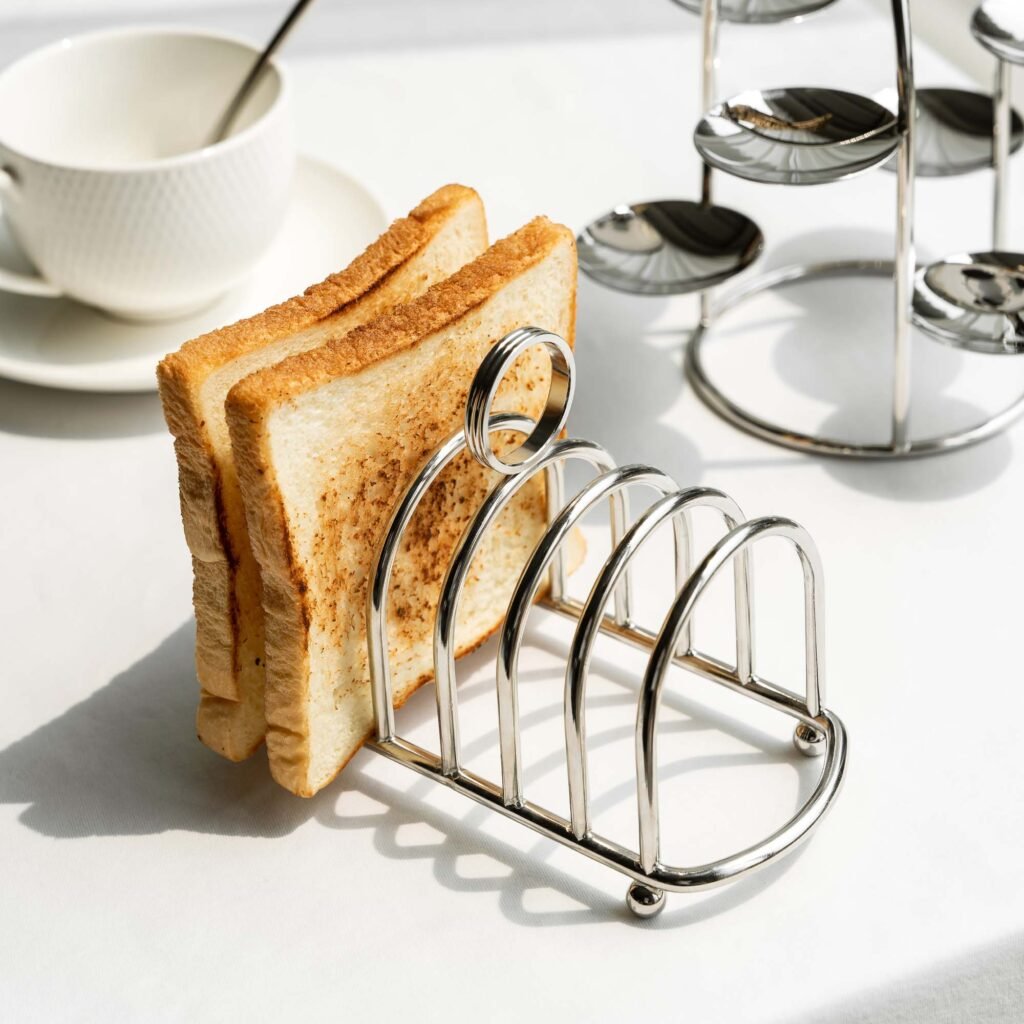 Close-up of the Modernist Linear Tableware, highlighting the precision-bent solid steel bars and the deep-set reflective finish.