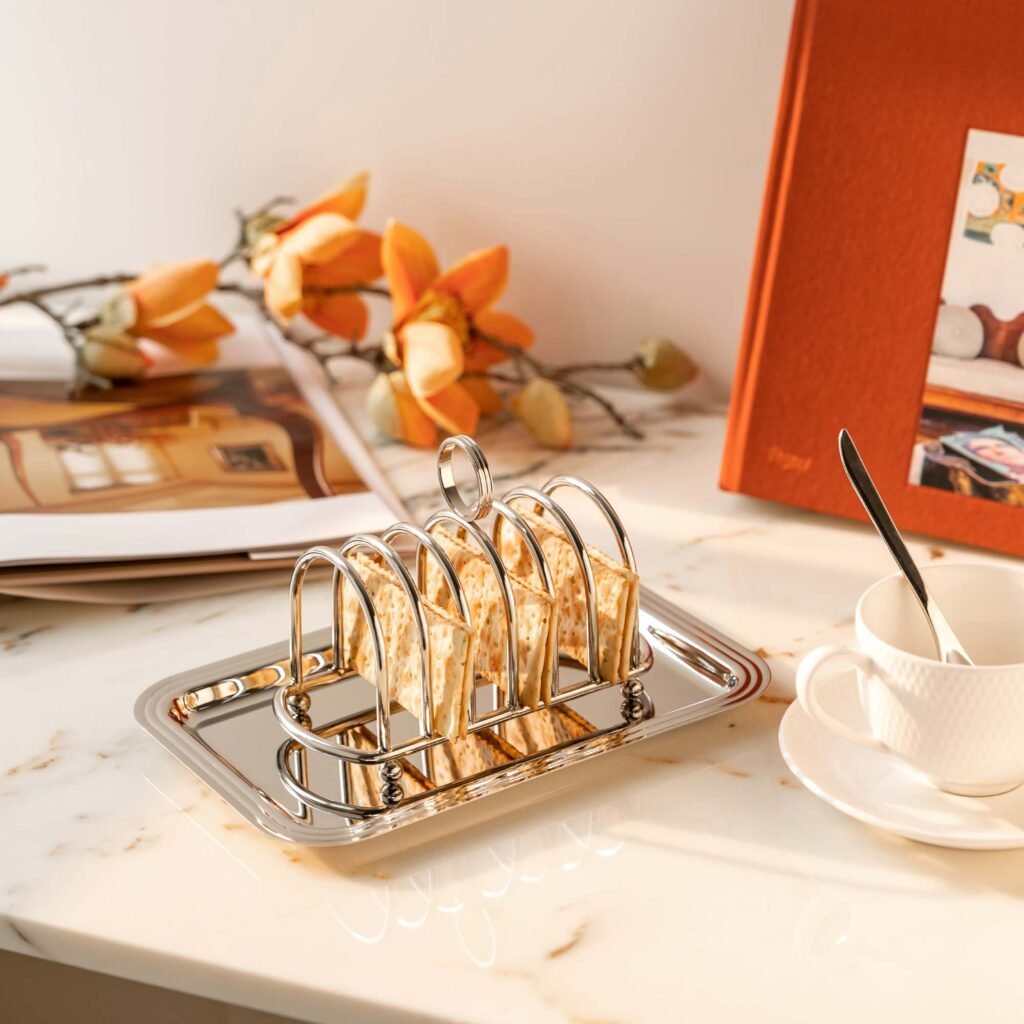 Steel Toast Rack placed on a white marble breakfast counter with golden-brown toast, representing Reflective Architectural Toast Organizer elegance.