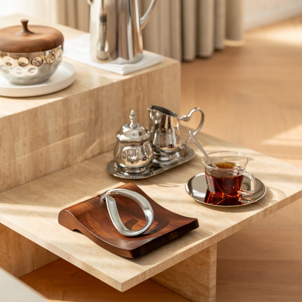 Steel Napkin Tray (SS-11) featuring a mirror-polished horizontal base with a sleek weighted cylindrical bar, showcased as a Luxury Mirror Polished Weighted Server.