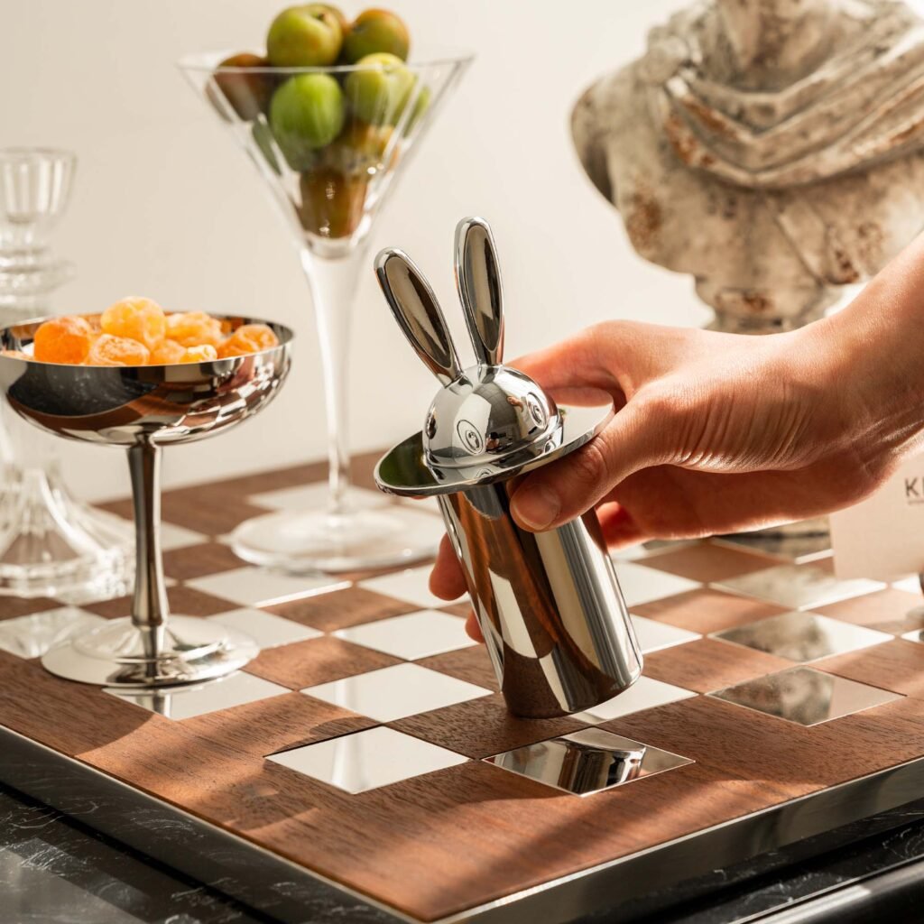 Steel Rabbit Toothpick holder standing on a minimalist tray, representing Reflective Whimsical Dining Art in a luxury setting