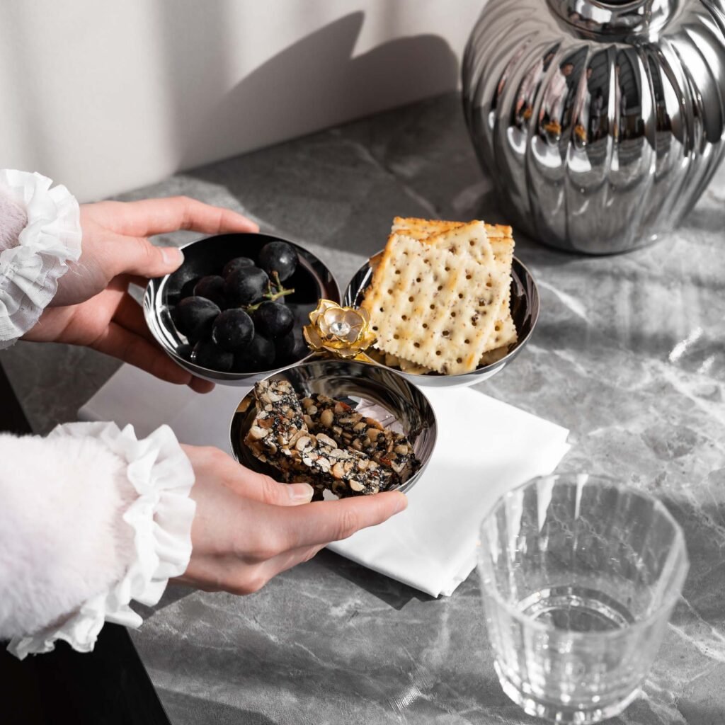 Steel Snack Bowl showcased as a Luxury Mirror Polished Appetizer Dish, reflecting a bright contemporary environment on its interior curves.