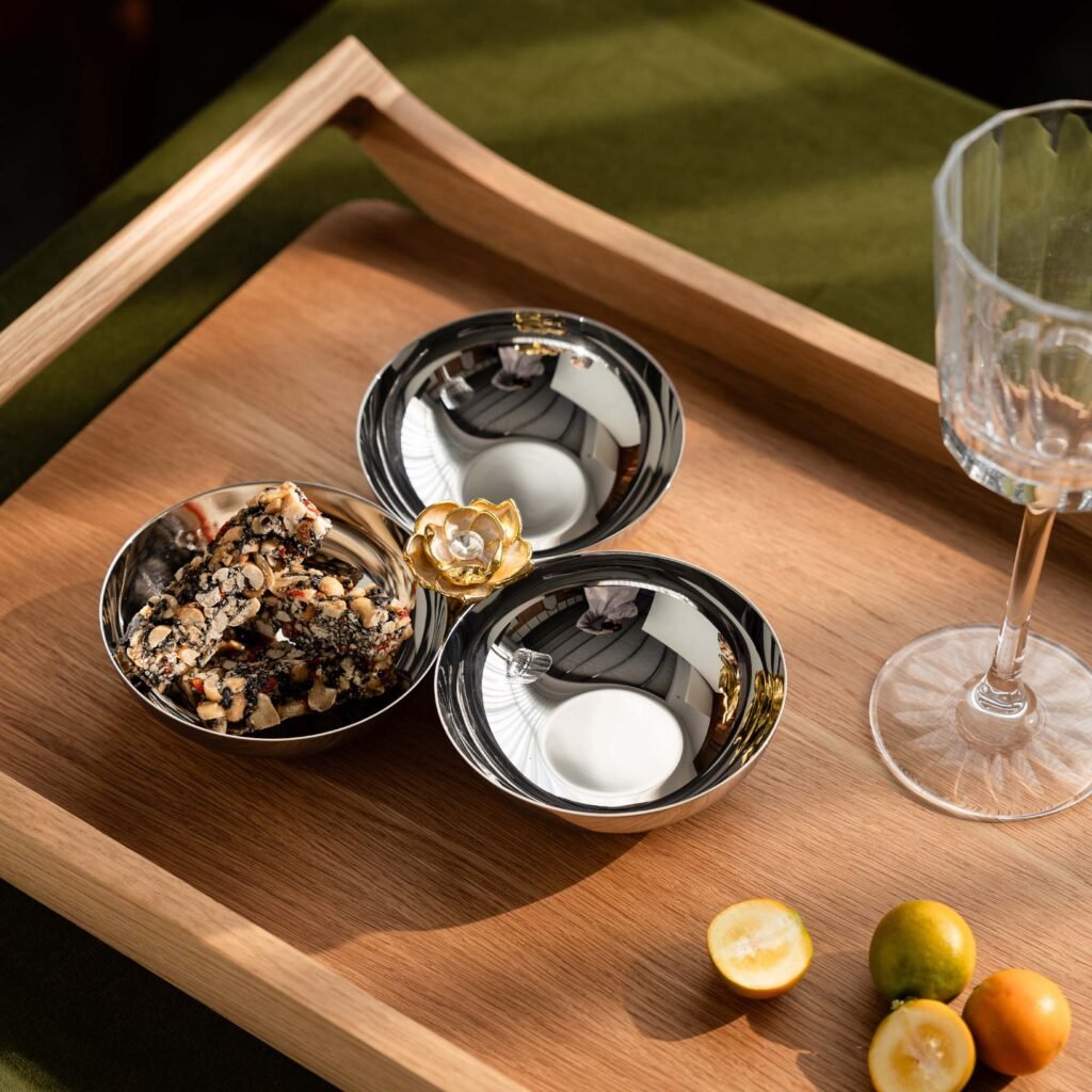 Close-up of the Modernist Metallic Server, highlighting the smooth, rounded rim and the flawless, high-gloss reflective finish.