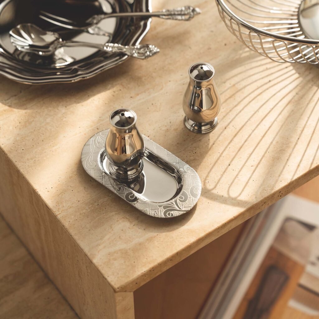 Close-up of the Modernist Metallic Kitchenware, highlighting the flawless reflective surface and the seamless screw-top mechanism.