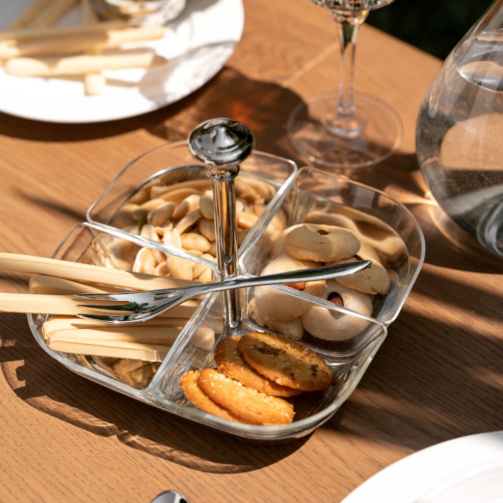 Glass Snack Server displayed on a modern coffee table with assorted nuts and dried fruits, representing Reflective Sectional Serving Dish elegance.
