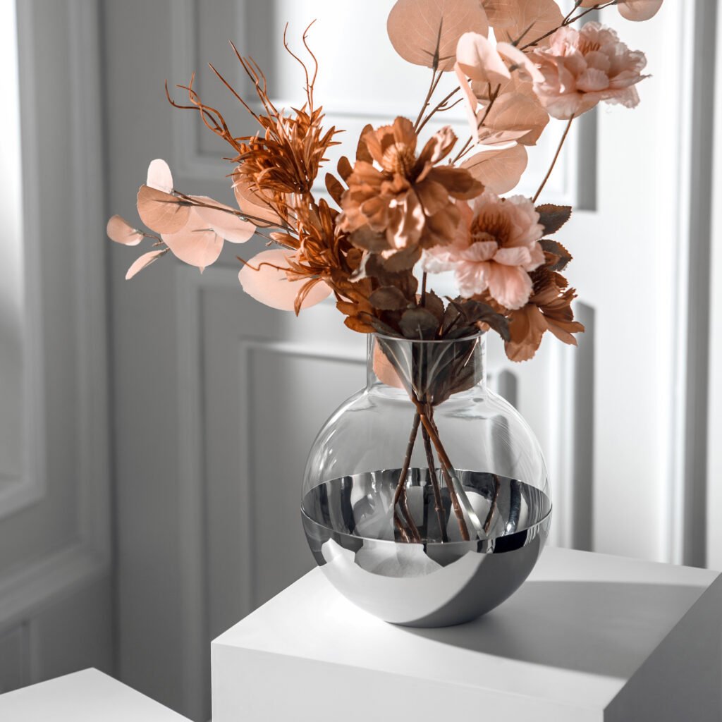 Close-up of the Modernist Spherical Centerpiece, highlighting the smooth circular aperture and the brilliant, deep-set reflective chrome finish.