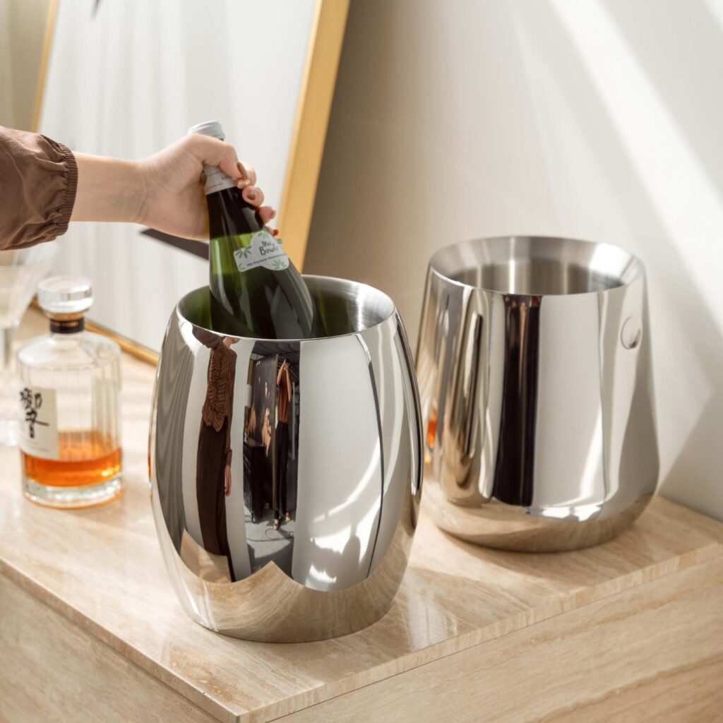 Steel Ice Bucket featuring a bold architectural flat handle and matching tongs, showcased as a Luxury Mirror Polished Wine Chiller.