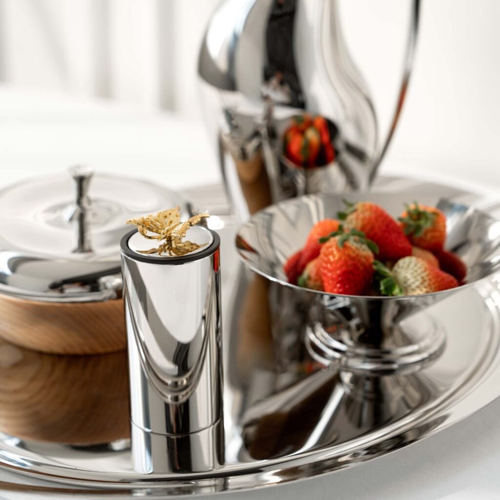 Close-up of the Modernist Nature-Themed Tableware, highlighting the detailed wing textures and the deep-set reflective chrome finish.