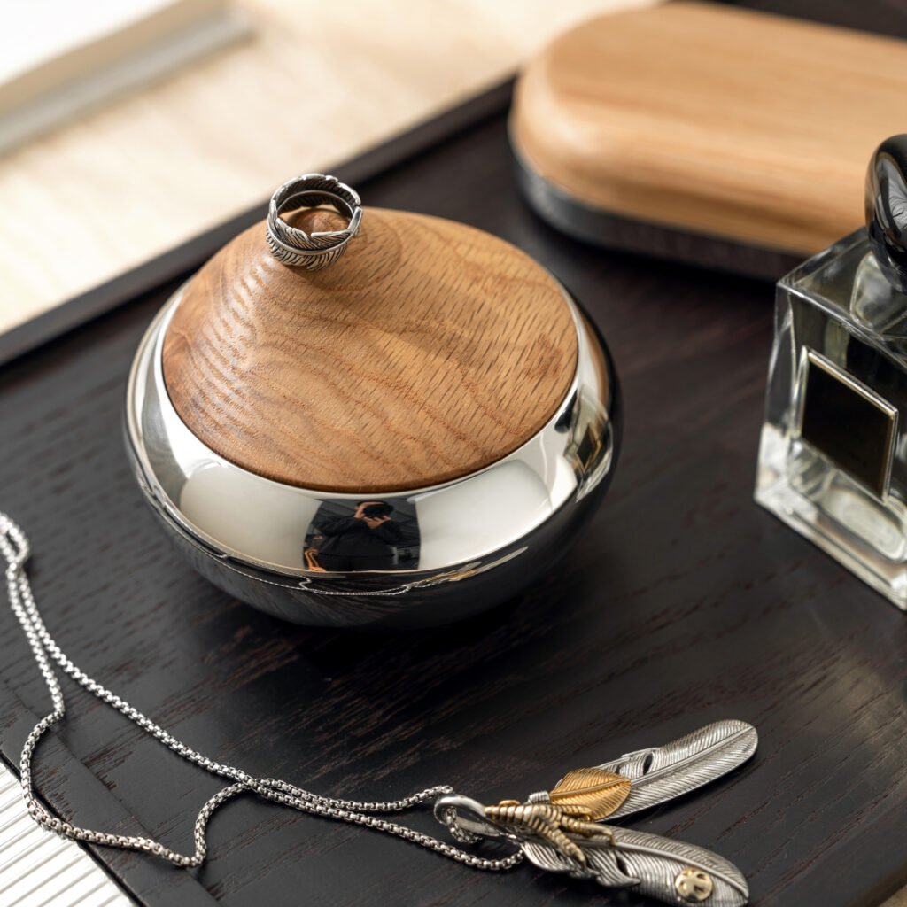 Steel Storage Canister placed on a dark walnut kitchen counter beside high-end coffee beans, representing Reflective High-End Functional Art elegance.