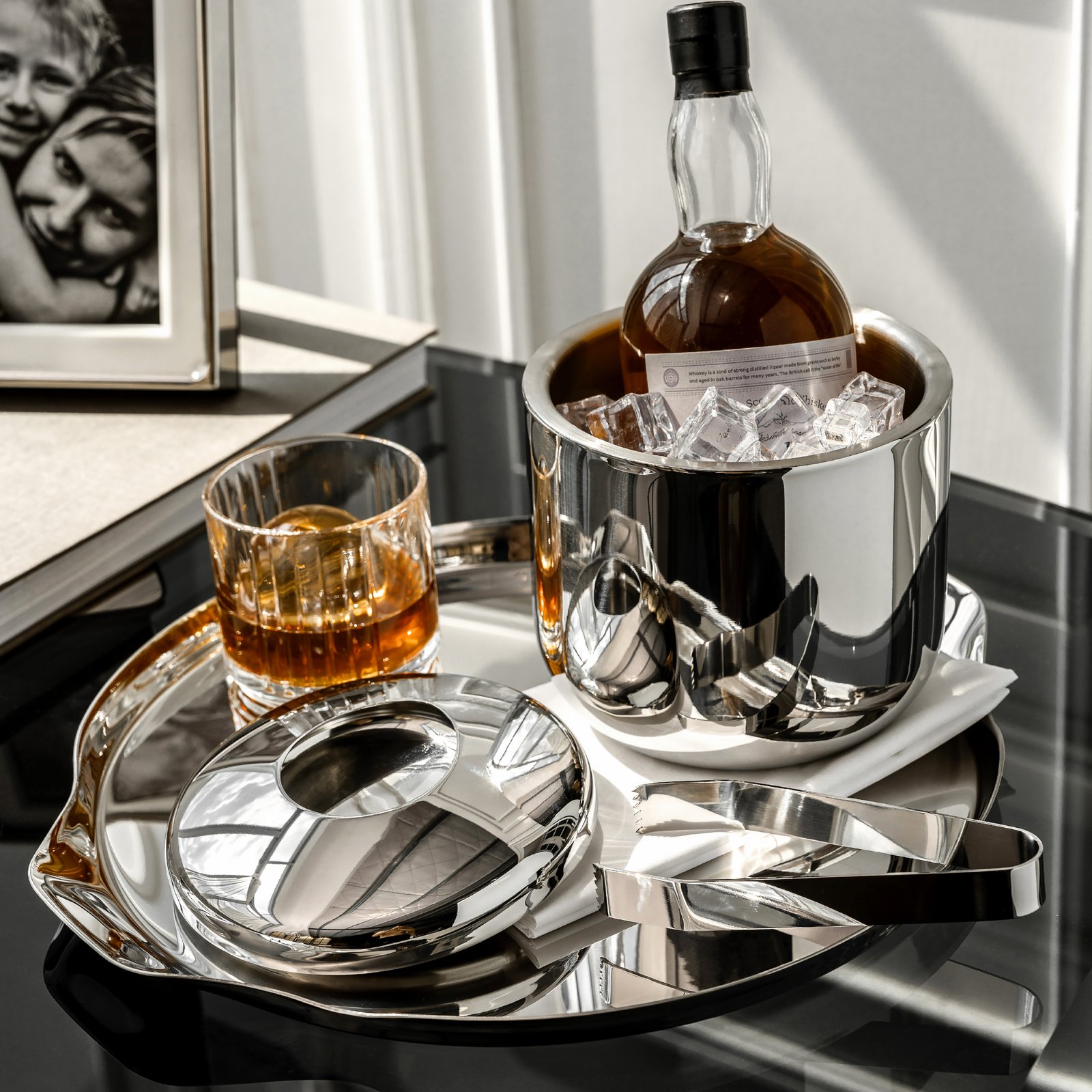 Steel Ice Bucket featuring a bold symmetrical loop handle and matching tongs, showcased as a Luxury Mirror Polished Wine Chiller.