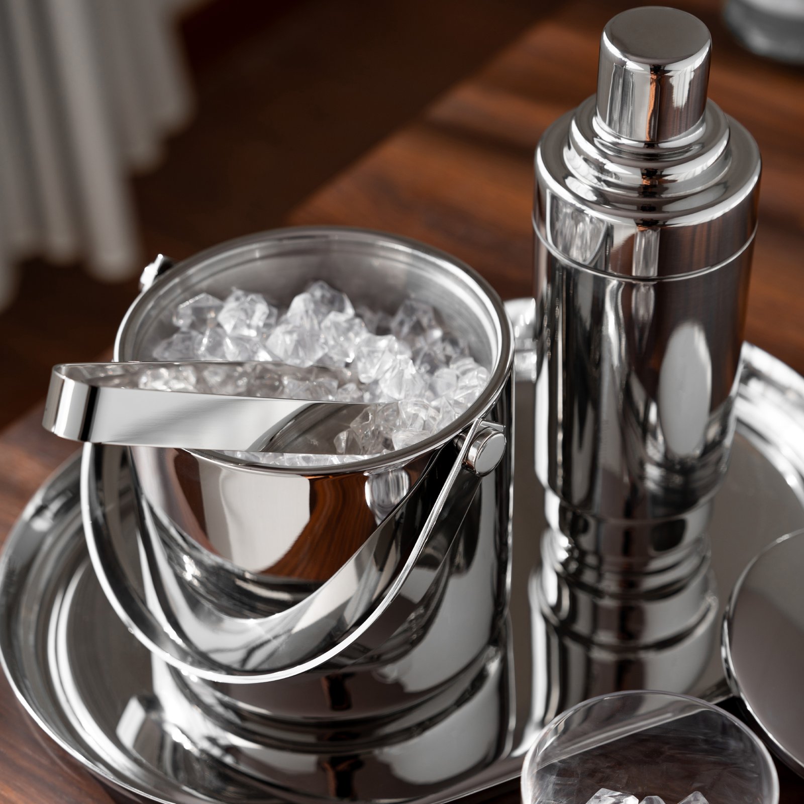 Steel Ice Bucket displayed in a contemporary penthouse setting, representing Reflective Modernist Tableware for high-end hospitality.