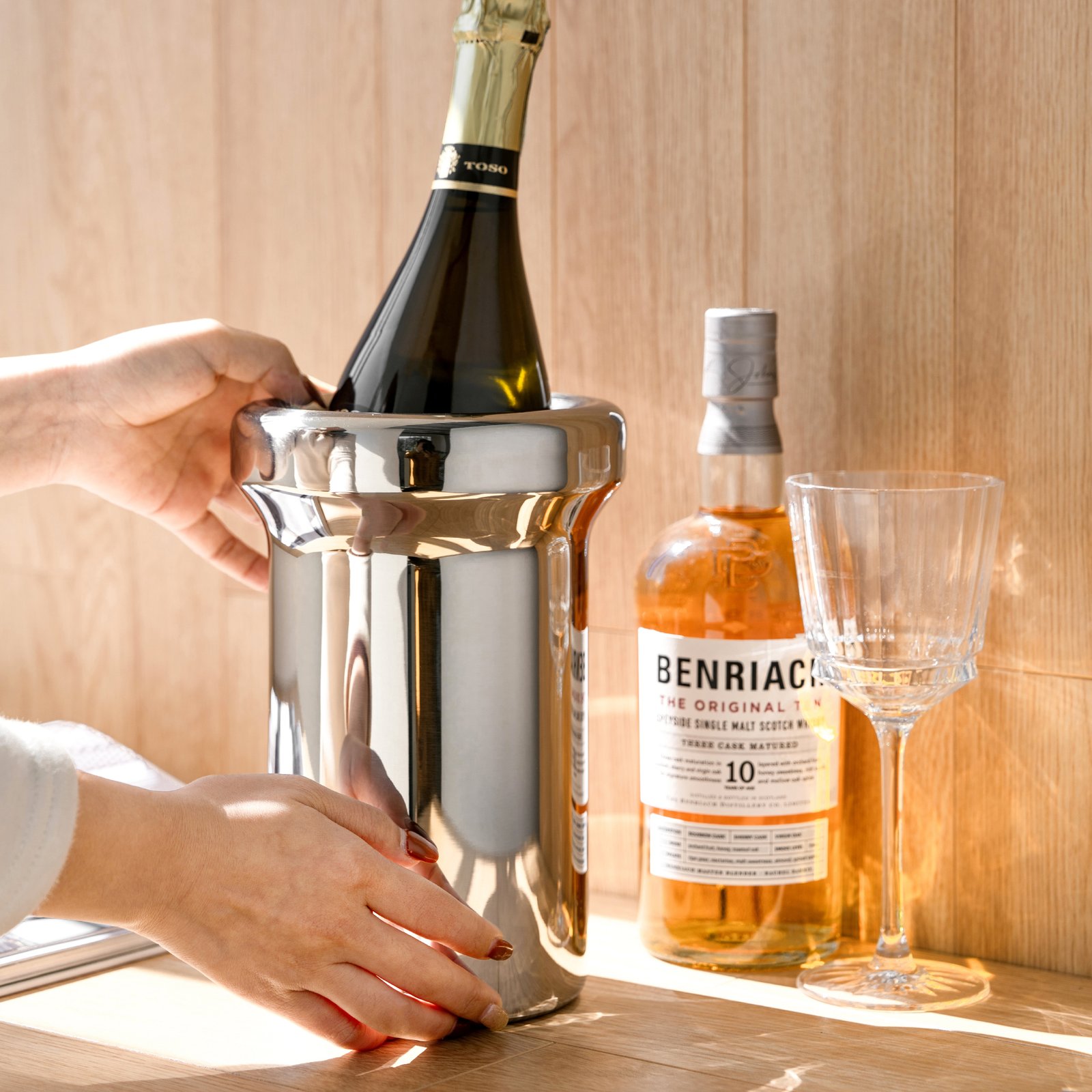 Steel Ice Bucket displayed in a high-end minimalist lounge setting, representing Reflective Modernist Tableware for elite hosting.