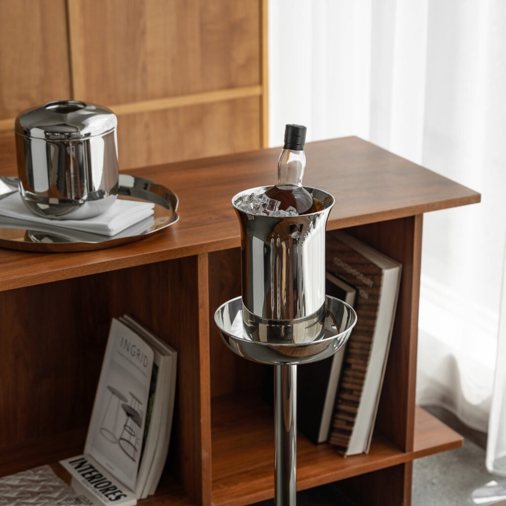 Steel Ice Bucket featuring a slim linear handle and matching tongs, showcased as a Luxury Mirror Polished Wine Chiller.