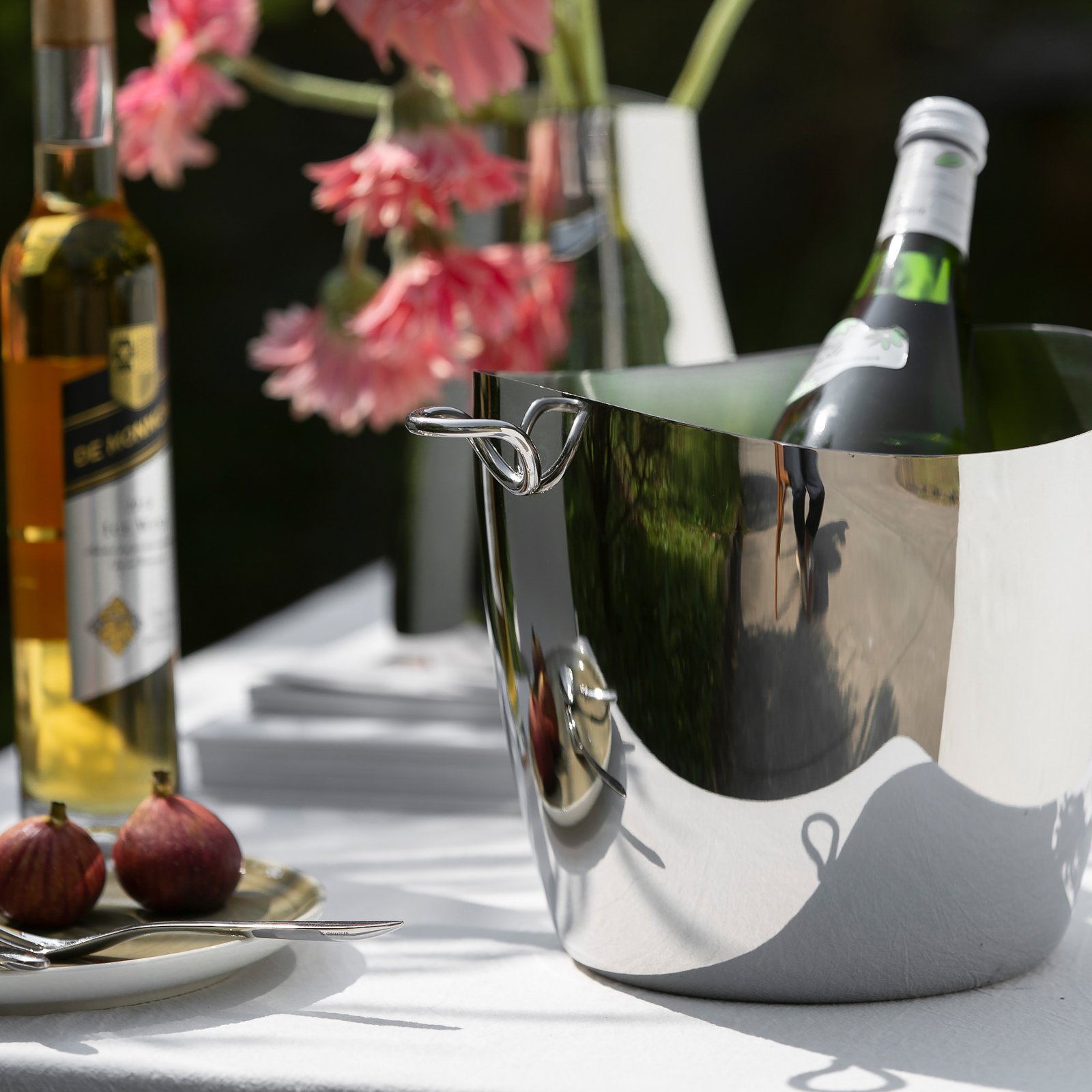 Steel Ice Bucket placed on a dark slate bar top, representing Reflective Modernist Tableware for high-end hospitality.