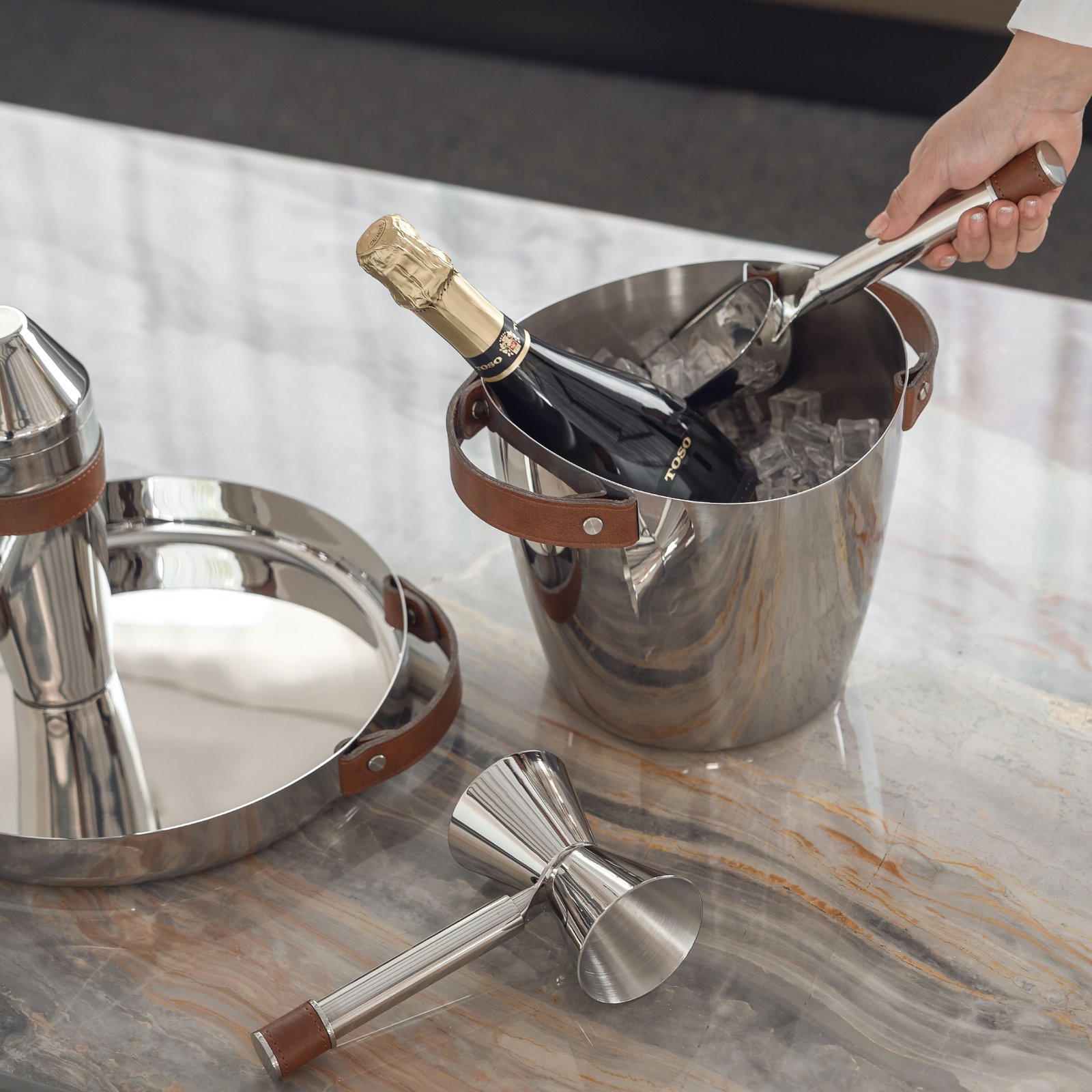 Leather Ice Bucket placed in a luxury lounge setting, representing Equestrian Style Metallic Cooler elegance for home bars.