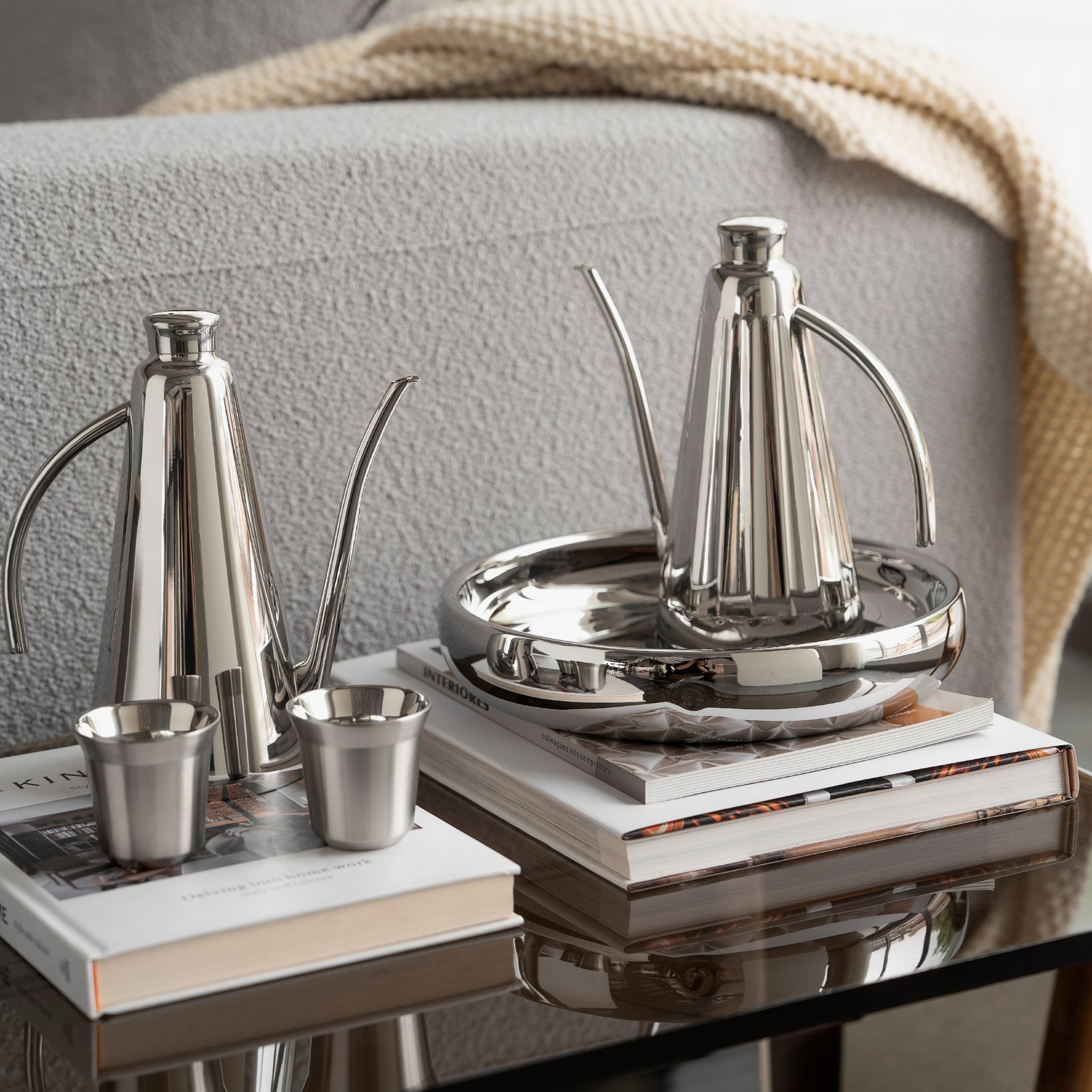 Steel Coffee Set featuring a cylindrical coffee pot and matching server, showcased as an Executive Metallic Coffee Service on a minimalist surface.