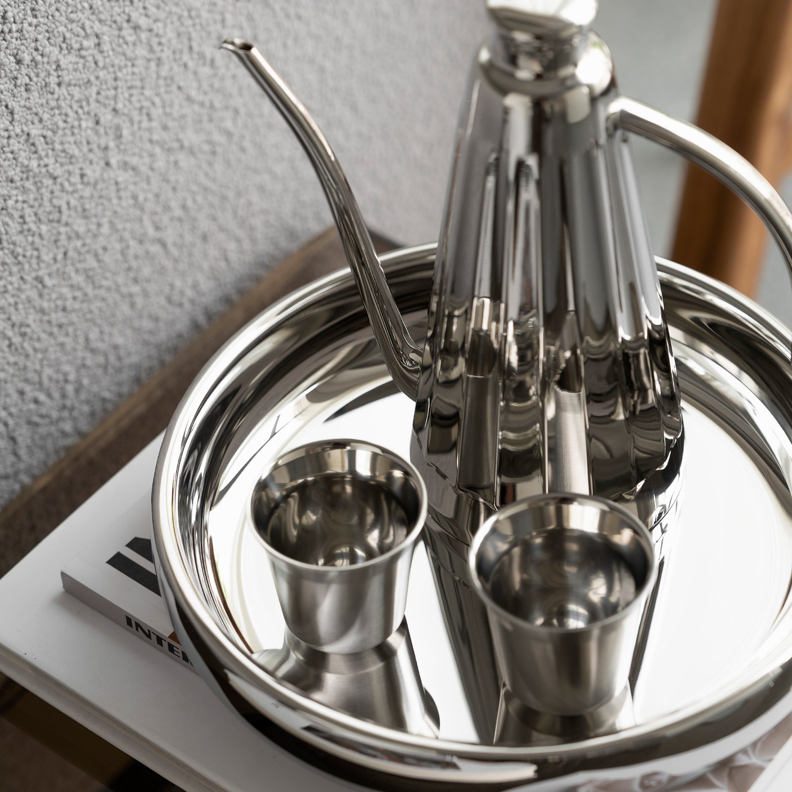 Close-up of the Luxury Mirror Polished Coffee Pot, highlighting the bold architectural ring handle and the seamless chrome-like reflection.