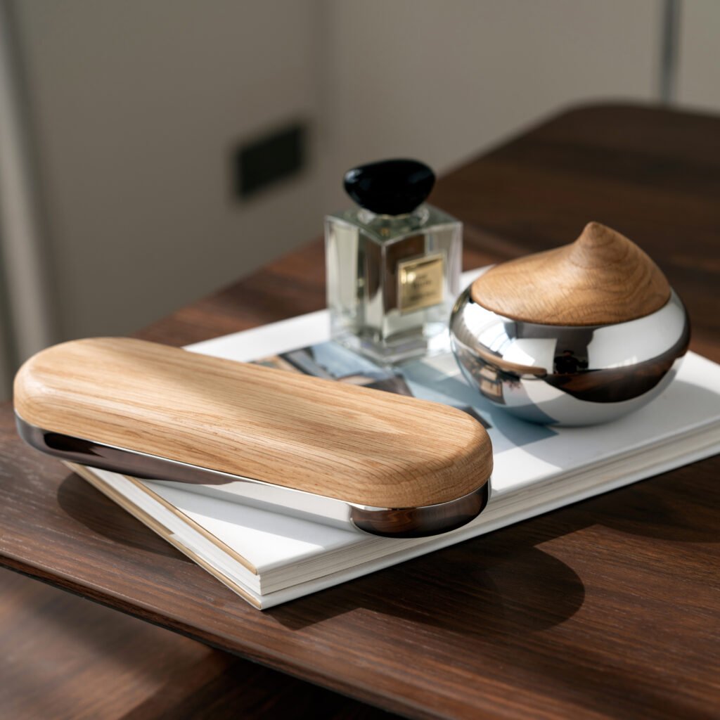 Close-up of the Modernist Low-Profile Metalware, highlighting the ultra-smooth surface and the flawless panoramic reflection of the interior space.