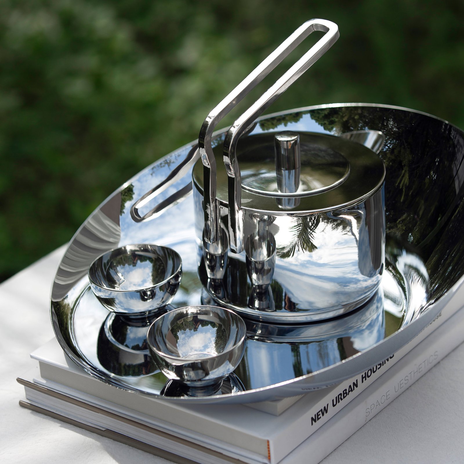 Modern Teapot standing solo on a dark wooden desk, showcased as a Luxury Mirror Polished Tea Server for professional environments.