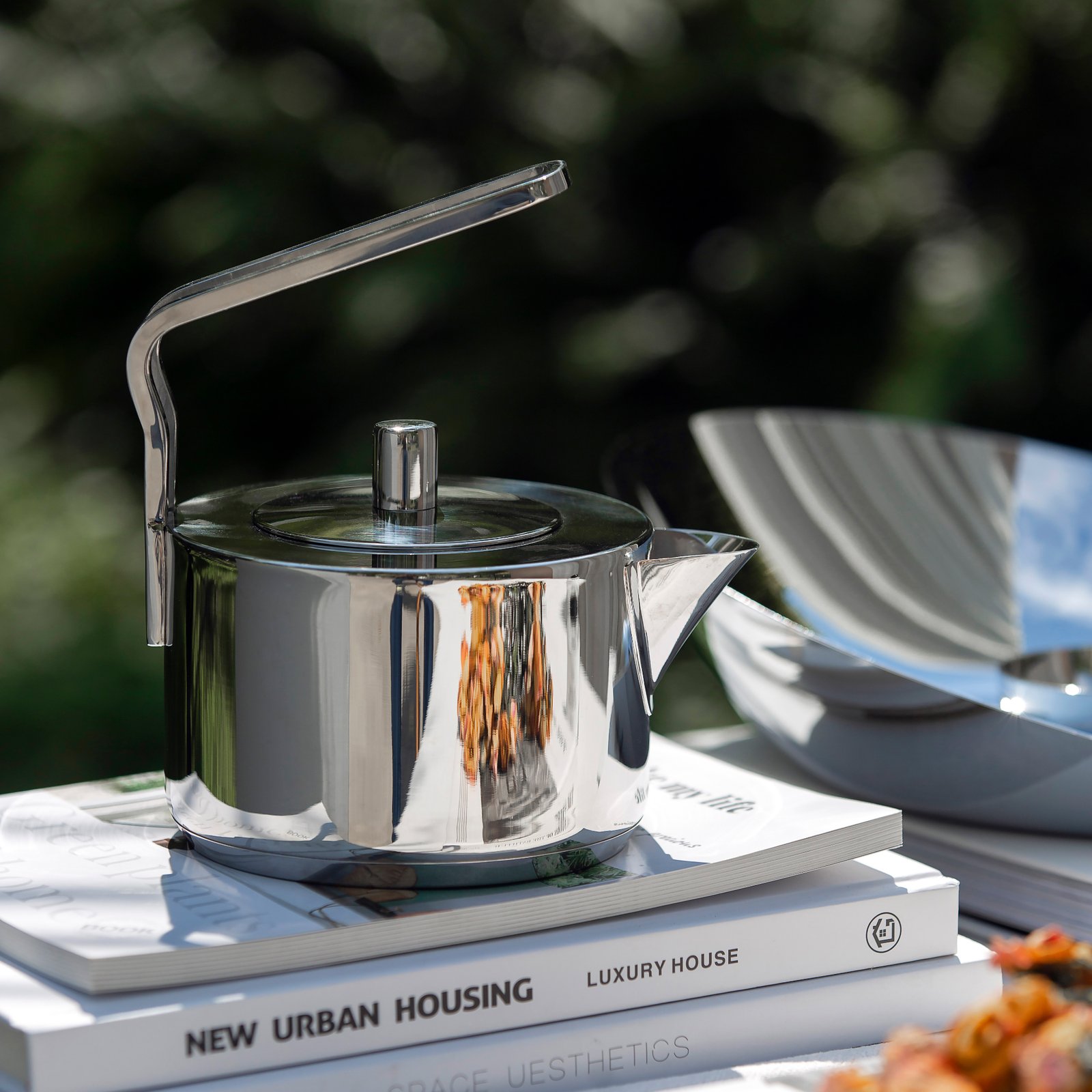 Close-up of the Bold Geometric Handle Pot, highlighting the wide-grip handle design and the flawless chrome-like reflection.