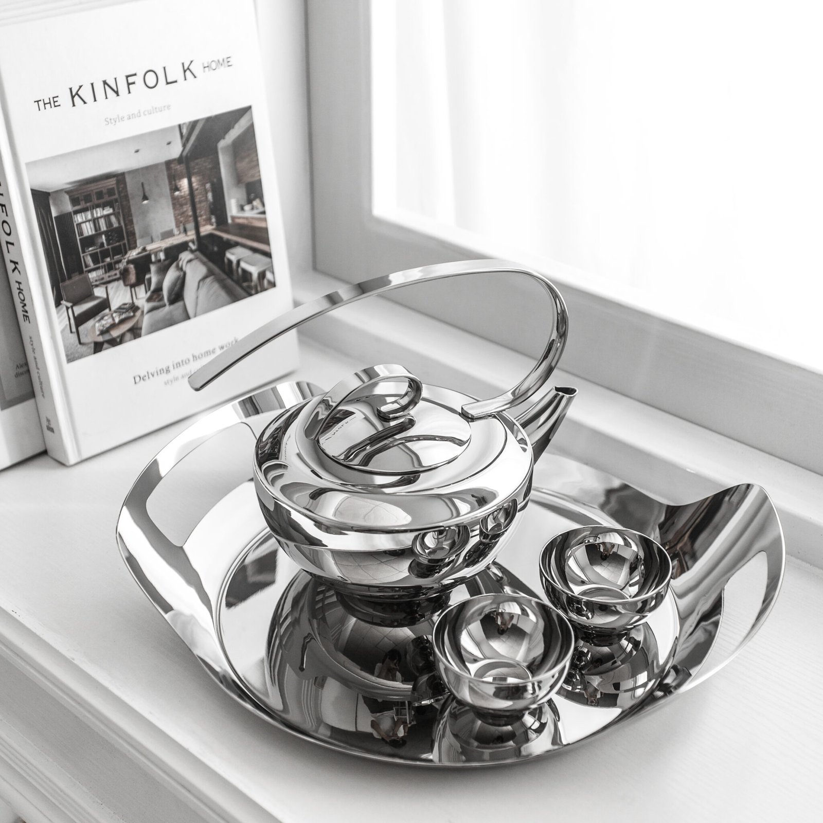 Steel Teapot Set including a cylindrical teapot and matching cups, showcased as a Premium Metallic Tea Suite on a minimalist tray.
