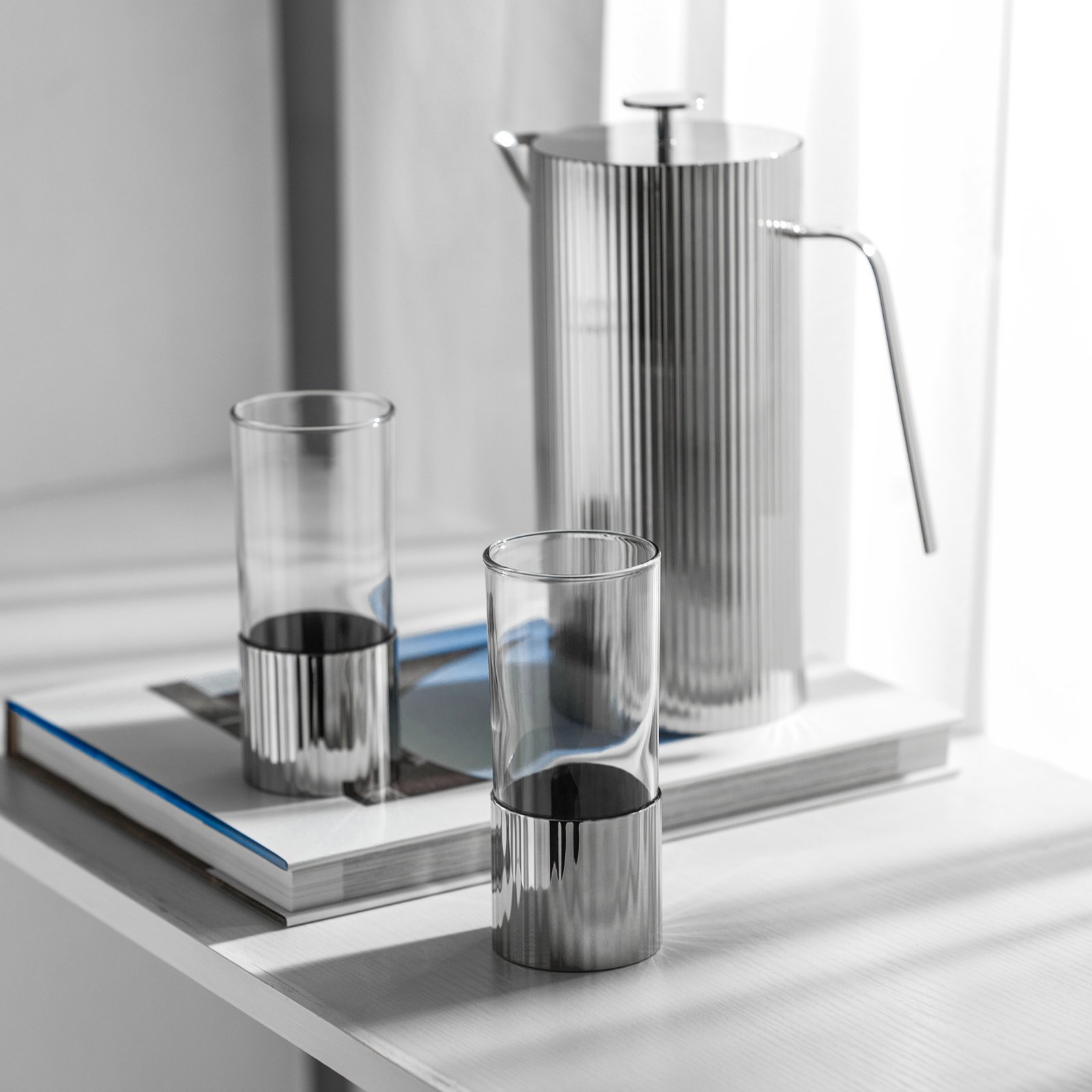 Close-up of the Luxury Mirror Polished Pitcher, highlighting the unique semi-circle handle and the seamless reflective surface.