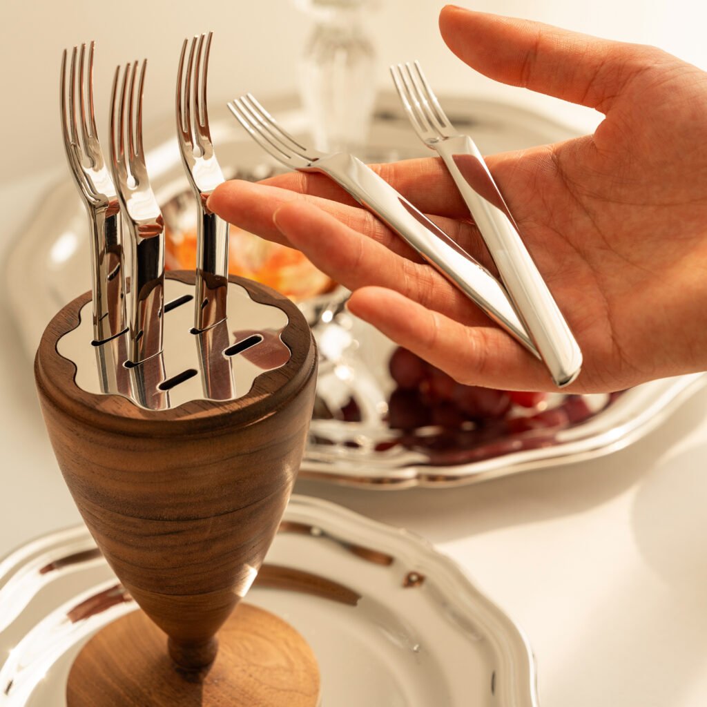 Close-up of the Modernist Weighted Metalware, highlighting the ultra-smooth flared rim and the flawless panoramic reflection of the surrounding interior.