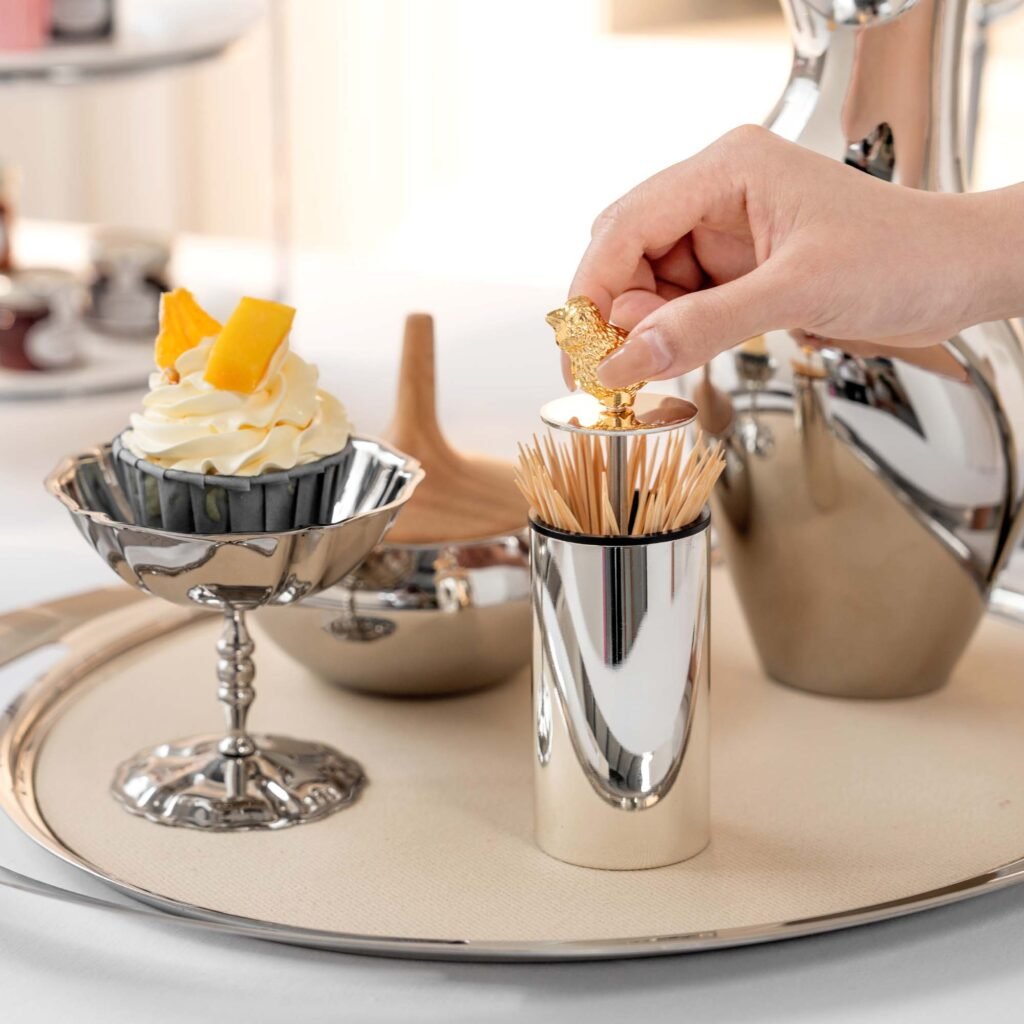 Close-up of the Modernist Nature-Themed Tableware, highlighting the detailed wing textures and the deep-set reflective chrome finish.