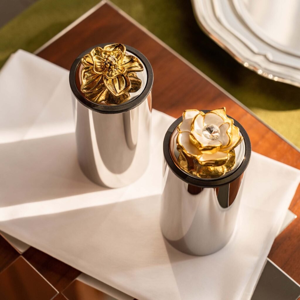 Steel Rose Toothpick holder standing on a white linen tablecloth, representing Reflective Botanical Dining Art in a luxury setting.