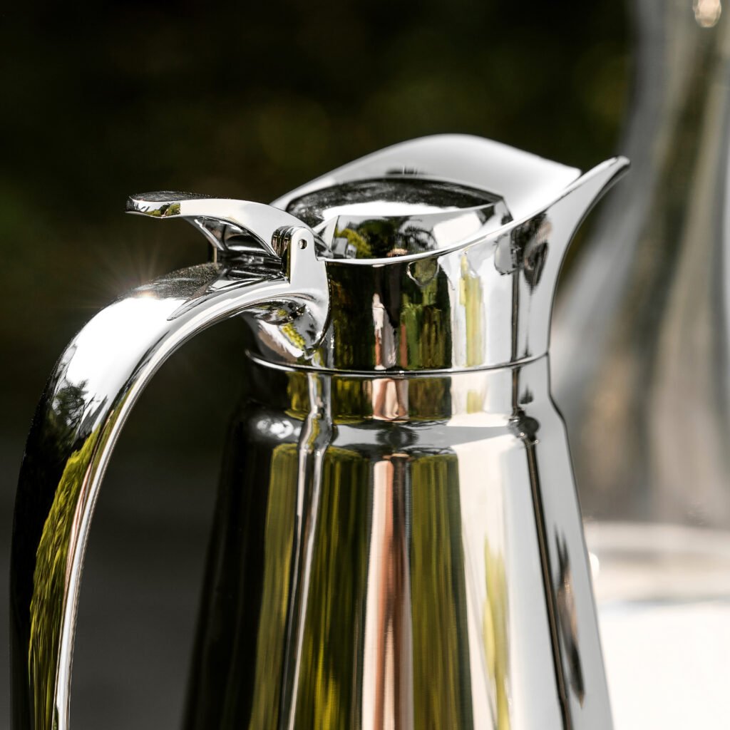 Close-up of the Modernist Architectural Metalware, highlighting the precision-fitted lid and the flawless, high-clarity reflective exterior of the steel cylinder.