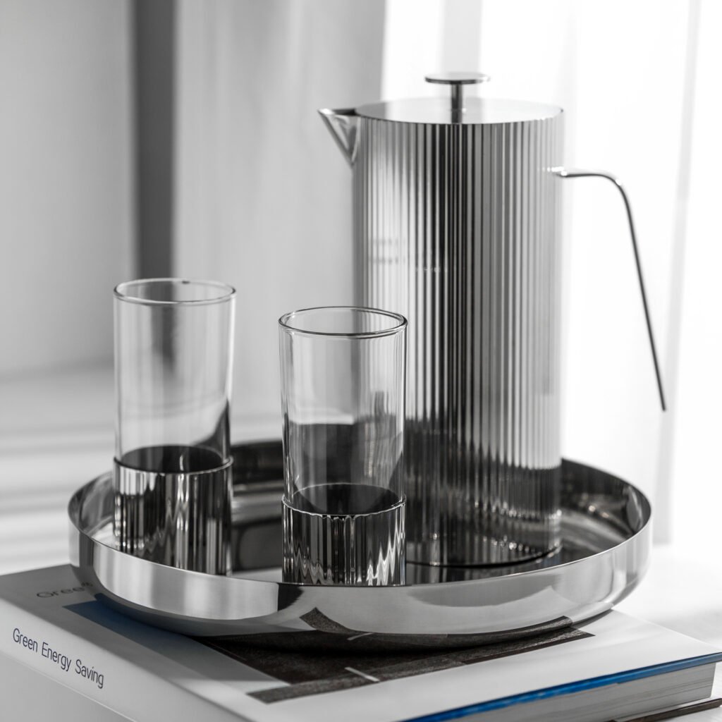 Close-up of the Modernist Textured Metalware, highlighting the rhythmic light reflection across the precision-machined steel ribs and the seamless lid fit.