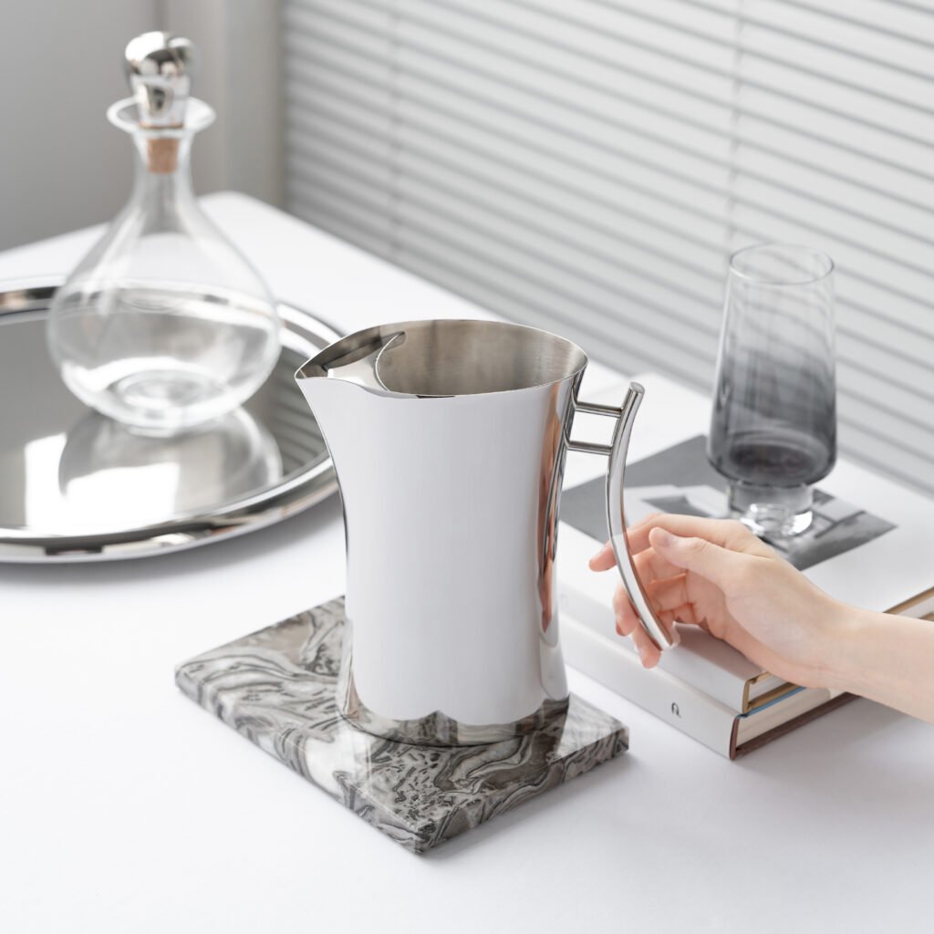Steel Water Pitcher (SS-27) featuring a mirror-polished conical body and an integrated ergonomic handle for professional beverage service, showcased as a Luxury Mirror Polished Beverage Server.