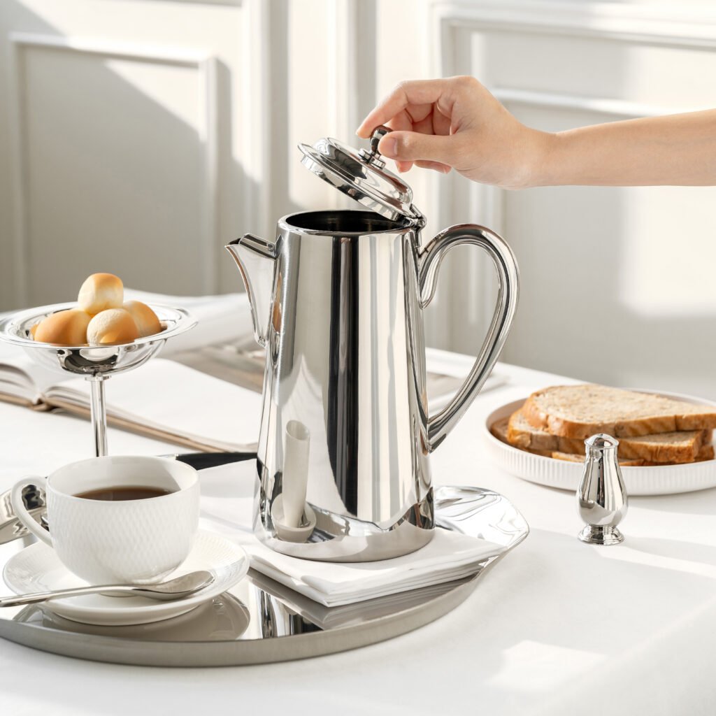 Steel Geometric Pitcher (SS-29) featuring a mirror-polished triangular body and a sharp geometric handle for professional coffee service, showcased as a Luxury Mirror Polished Coffee Server.