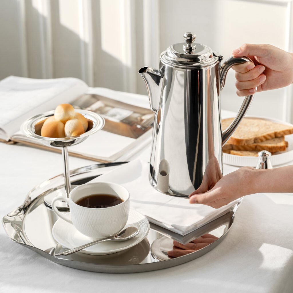 Close-up of the Modernist Structural Metalware, highlighting the precision-angled spout and the flawless, multi-dimensional reflection across the steel facets.