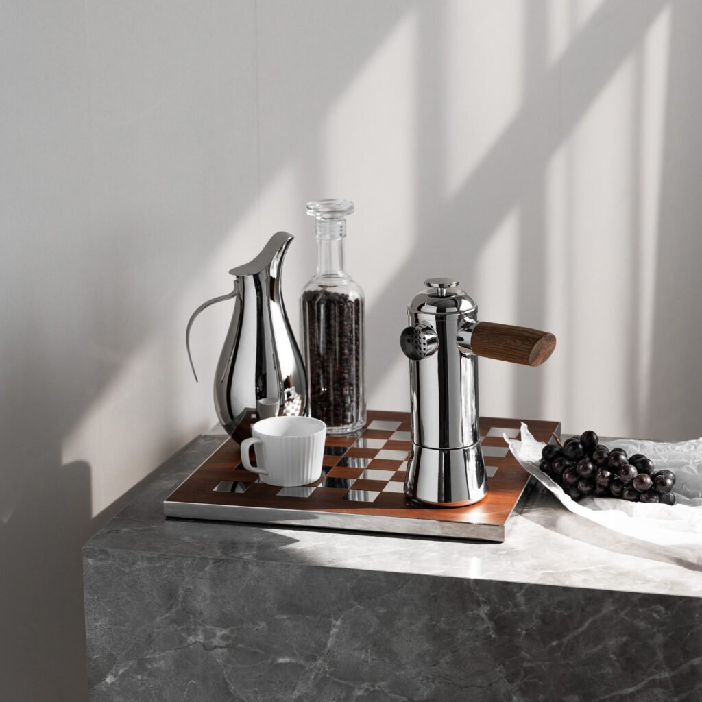 Steel Moka Pitcher (SS-31) featuring a mirror-polished high-neck body and a dramatic sweeping handle, showcased as a Luxury Mirror Polished High-Neck Server.