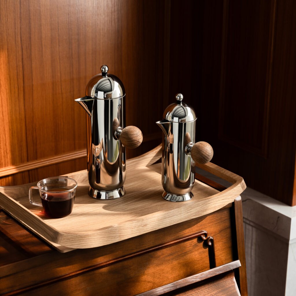 Close-up of the Modernist Deconstructive Metalware, highlighting the flawless reflection between the orb grip and the slanted steel neck.