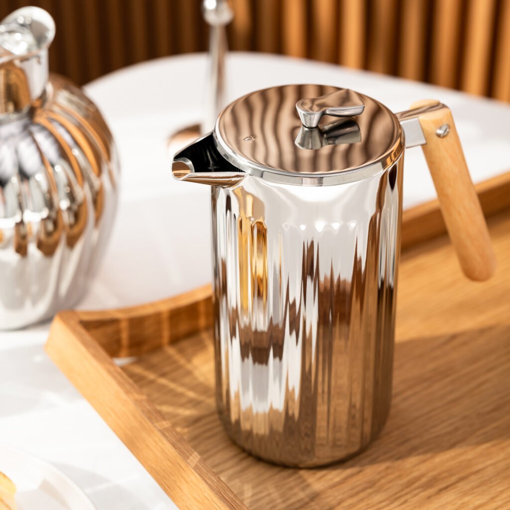 Steel Curved Pitcher (SS-33) featuring a mirror-polished S-shaped body and integrated flowing handle, showcased as a Luxury Mirror Polished Fluid Server.
