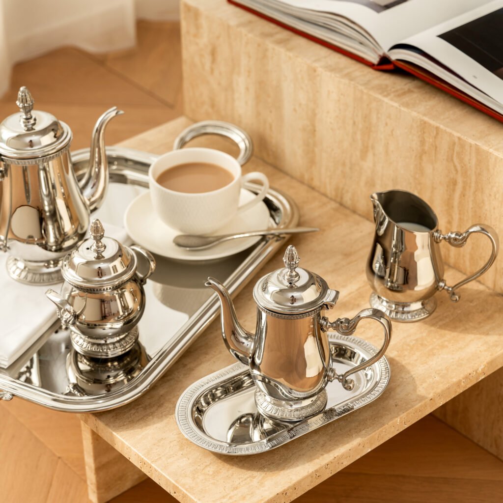Steel French Press placed on a concrete-textured countertop with minimalist ceramics, representing Reflective High-End Architectural Art elegance.