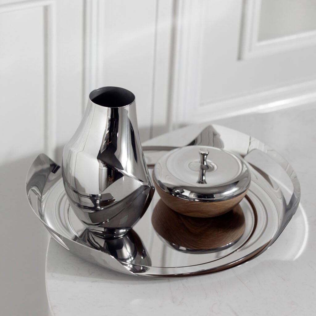 Close-up of the Modernist Cylindrical Metalware, highlighting the precision-machined top rim and the flawless, panoramic reflective exterior of the steel vase.